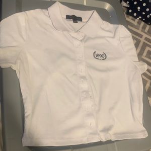 cropped polo shirt with “1999” on it.